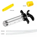 Clear bleed syringe with black handle, yellow accessories and illustrated tubing lengths