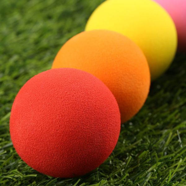 red orange yellow and pink practice golf ball