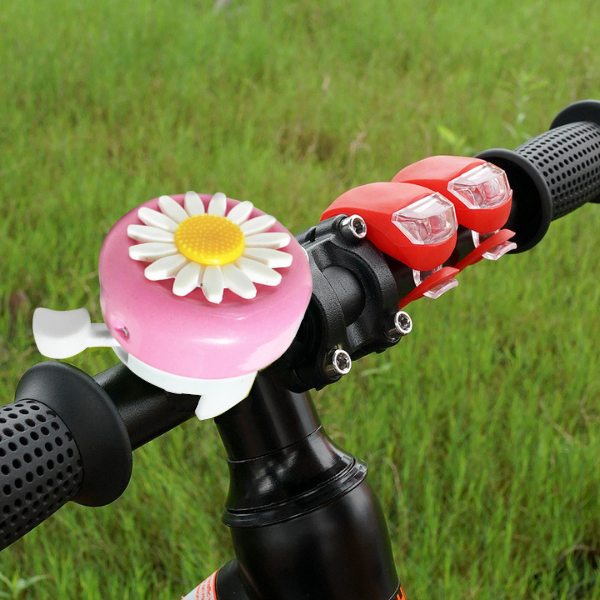 pink and white daisy flower kids bicycle bell on a bike