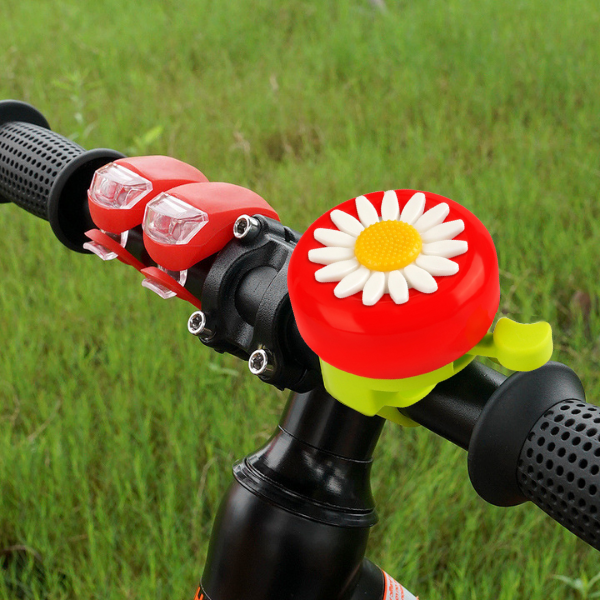 red and green daisy flower kids bicycle bell on a bike