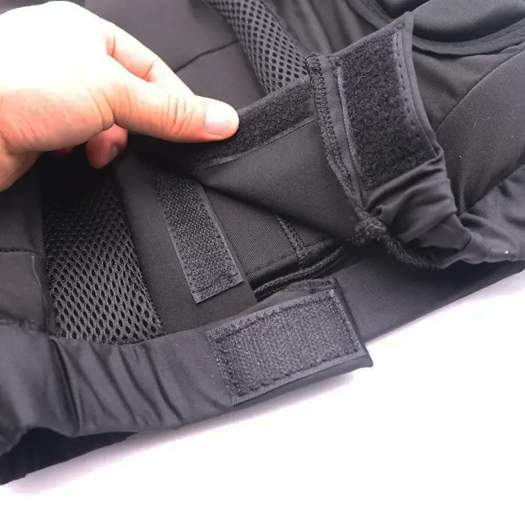 Close up of hook and loop waistband fastening tabs on black padded shorts