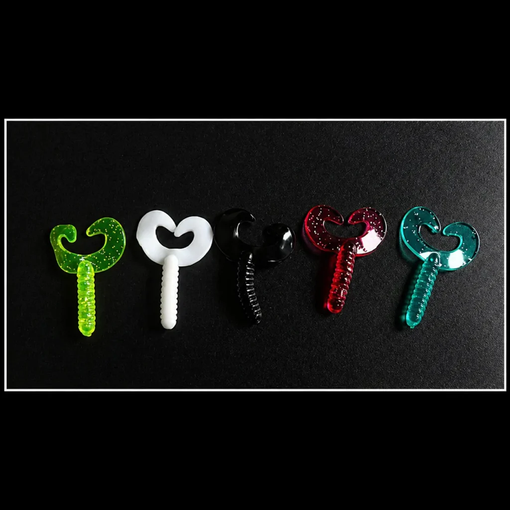 Assorted dual curly tail soft bait grubs in green, white, black, red and blue colours