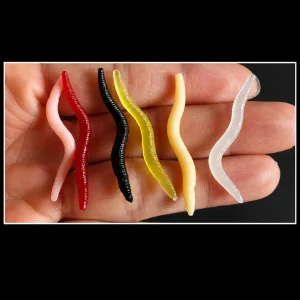 Assorted worm-style soft baits in red, black, yellow, cream, pink and translucent colours