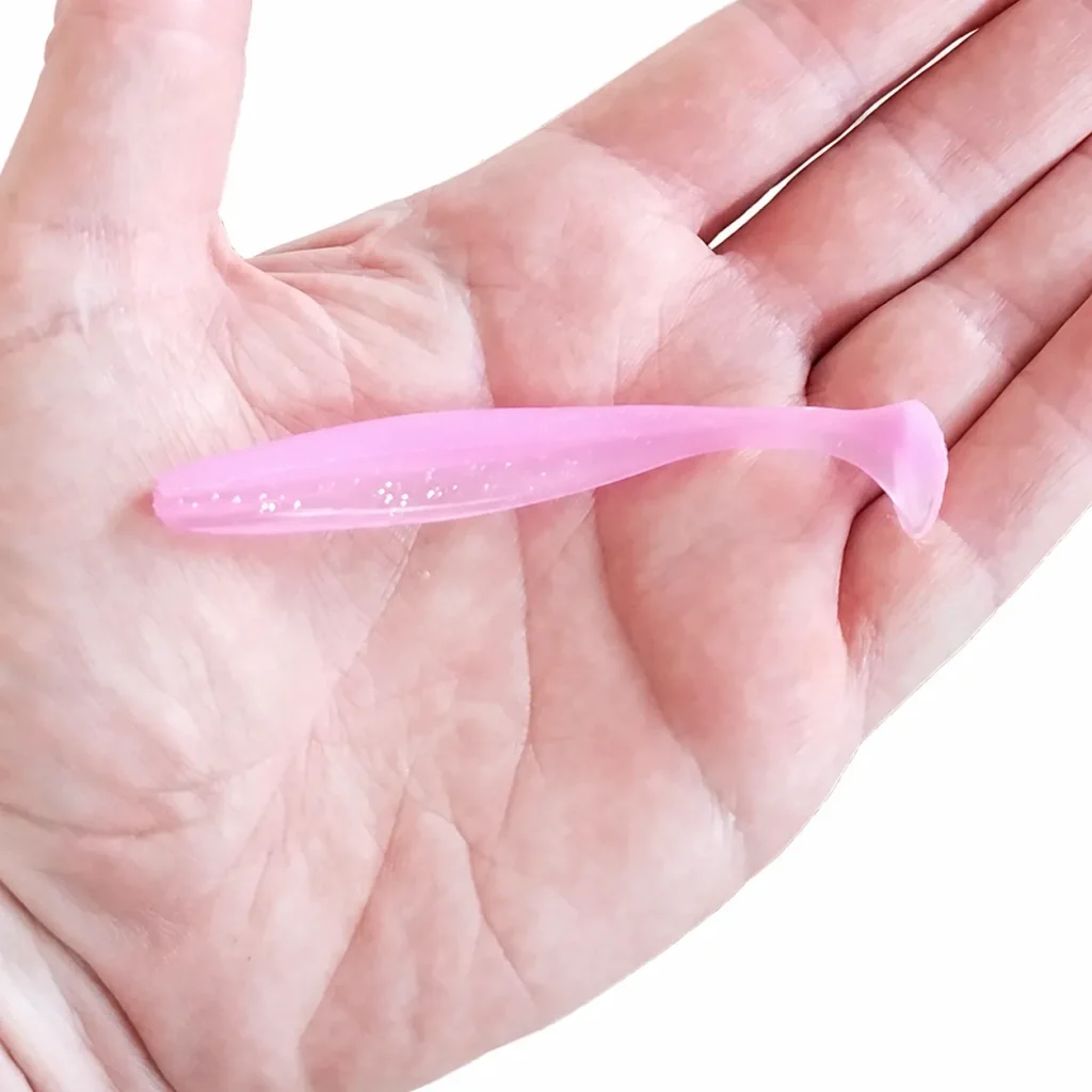 Suckerme soft bait shown on a hand for size reference