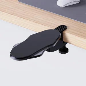 Black desk arm rest clamped to a wooden desk edge beside a computer mouse mat