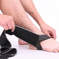 Ankle strap being positioned around the foot before fastening the adjustable wrap