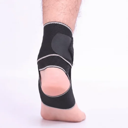 Black and grey ankle strap worn around the ankle with the heel exposed