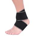 Black and grey ankle strap worn on the ankle with wrap-around support panels visible