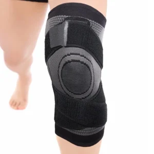 Black and grey knee sleeve worn on a leg showing the front kneecap support panel and straps