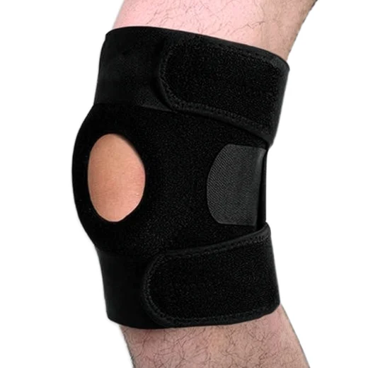Black knee support brace worn on a knee showing the open patella design and adjustable straps