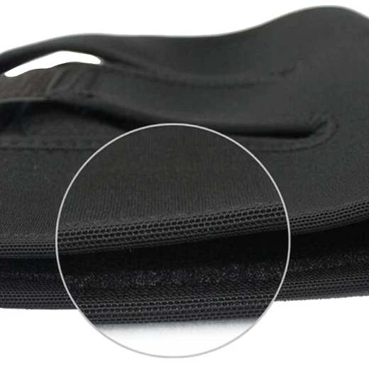 Close-up of the black knee support brace fabric and stitched edge detail