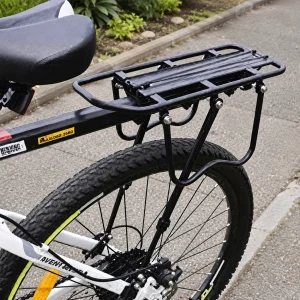 Side view of a black pannier rack fitted to a bike seat tube and rear wheel area