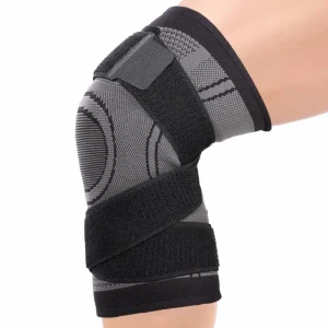 Side view of the black and grey knee sleeve showing the adjustable strap design around the knee