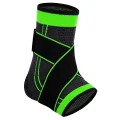 Black and green ankle brace with crossover straps shown on a white background