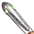 Close-up of a Suckerme 6oz grapnel sinker body with green glow beads and folded wire spikes