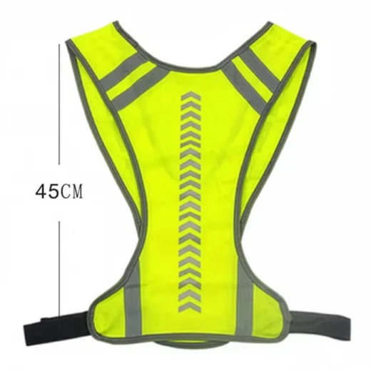 Fluorescent yellow hi vis vest laid flat showing its 45 cm length, reflective back markings and adjustable waist straps