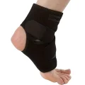 Front-side view of the black ankle support brace fitted around the foot with crossed straps and open heel