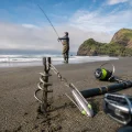 Suckerme 6oz grapnel sinker attached to a surfcasting rig on a sandy New Zealand beach