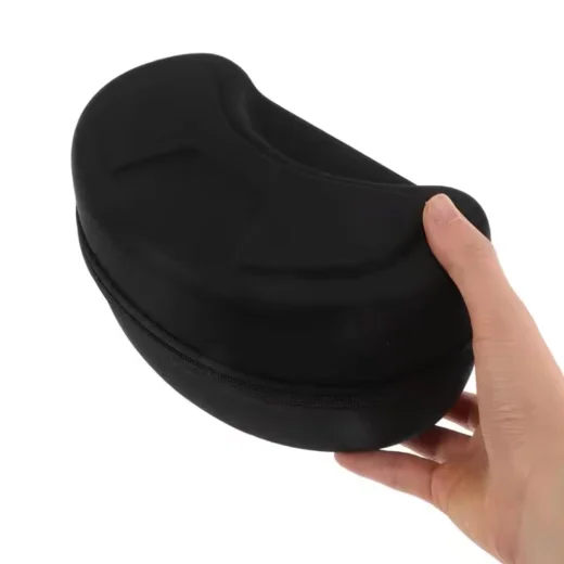 Black snow goggle case held in one hand to show compact size and hard shell shape