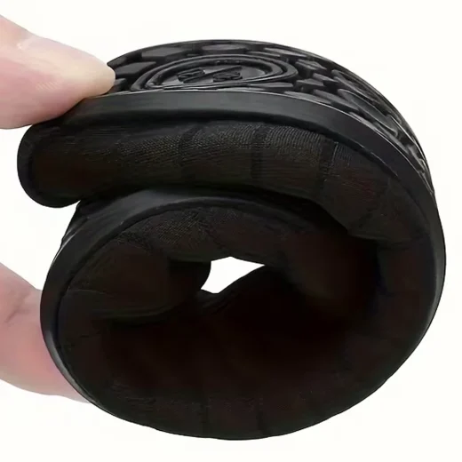 Black water shoe folded by hand to demonstrate its flexible construction